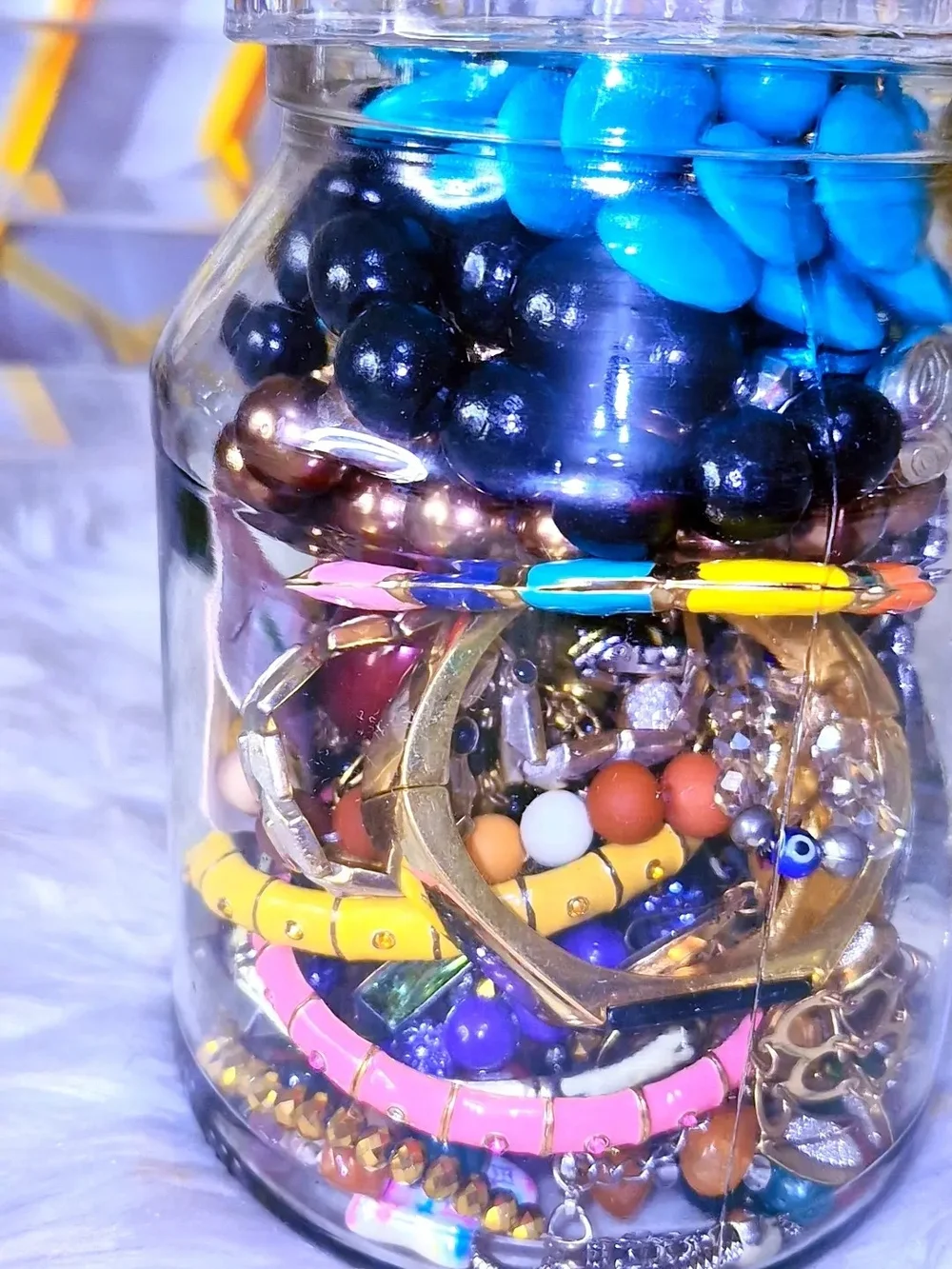 Decorative Glass Jar Filled with Assorted Blue and Multicolor Jewelry Accents
